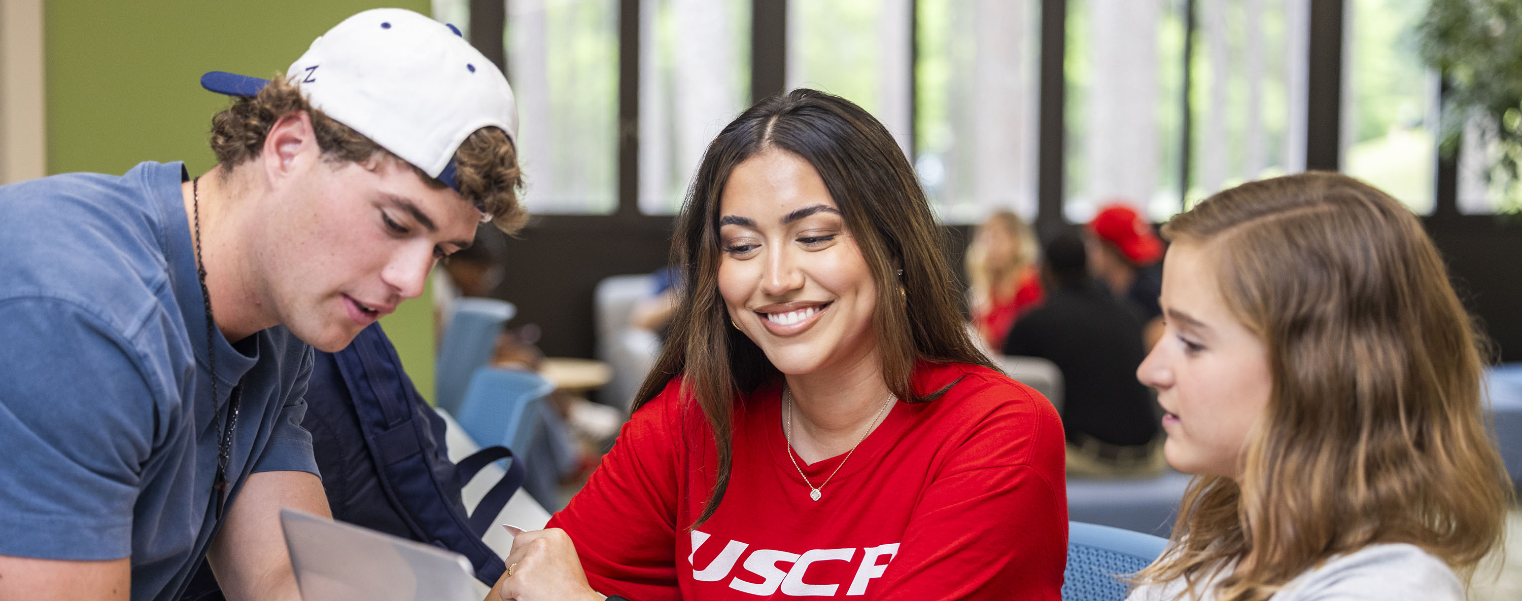 Image of three students collaborating on a project