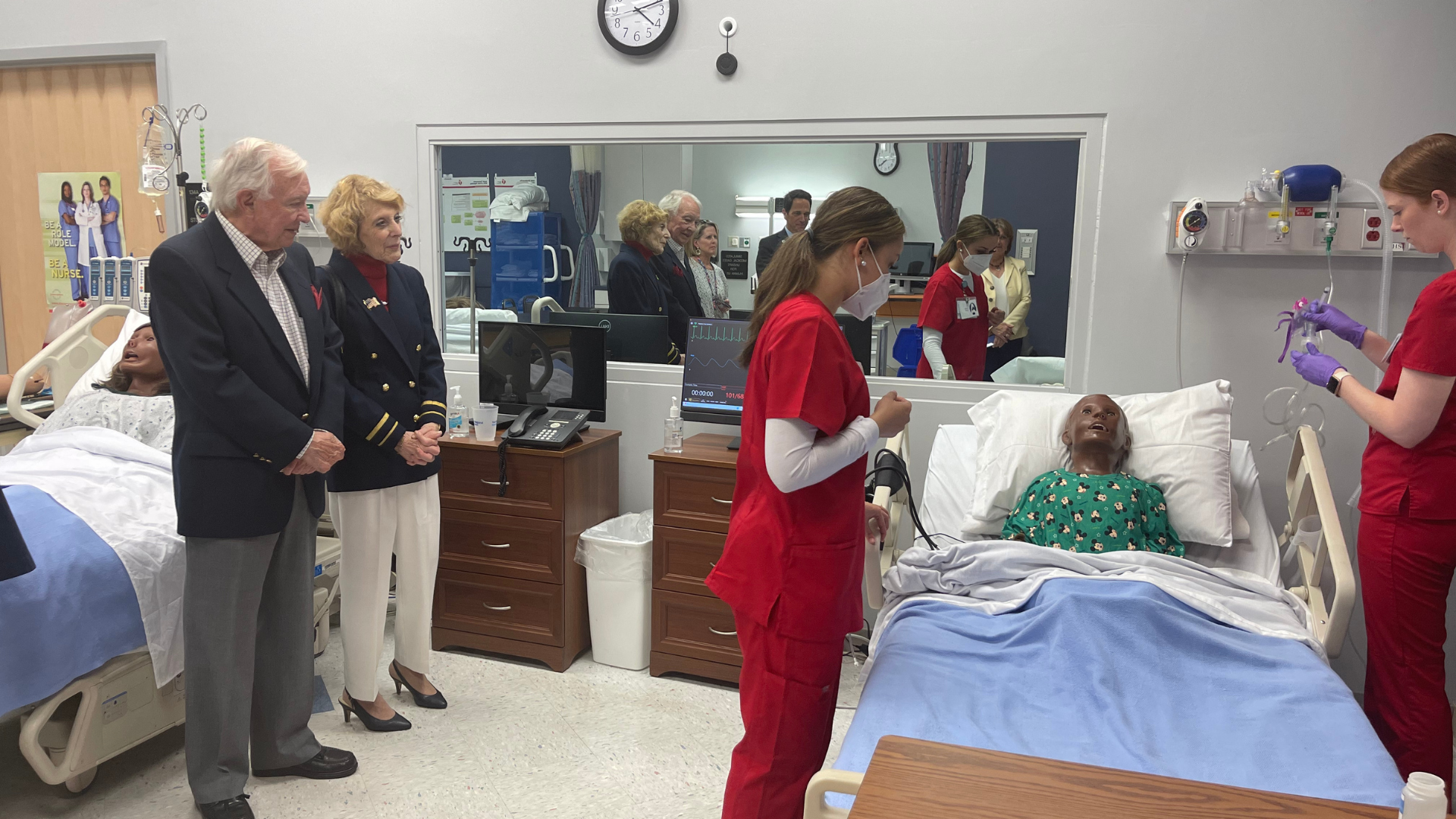 Nursing students perform mock medical procedures in front of Jerry and Lynn Bishop.
