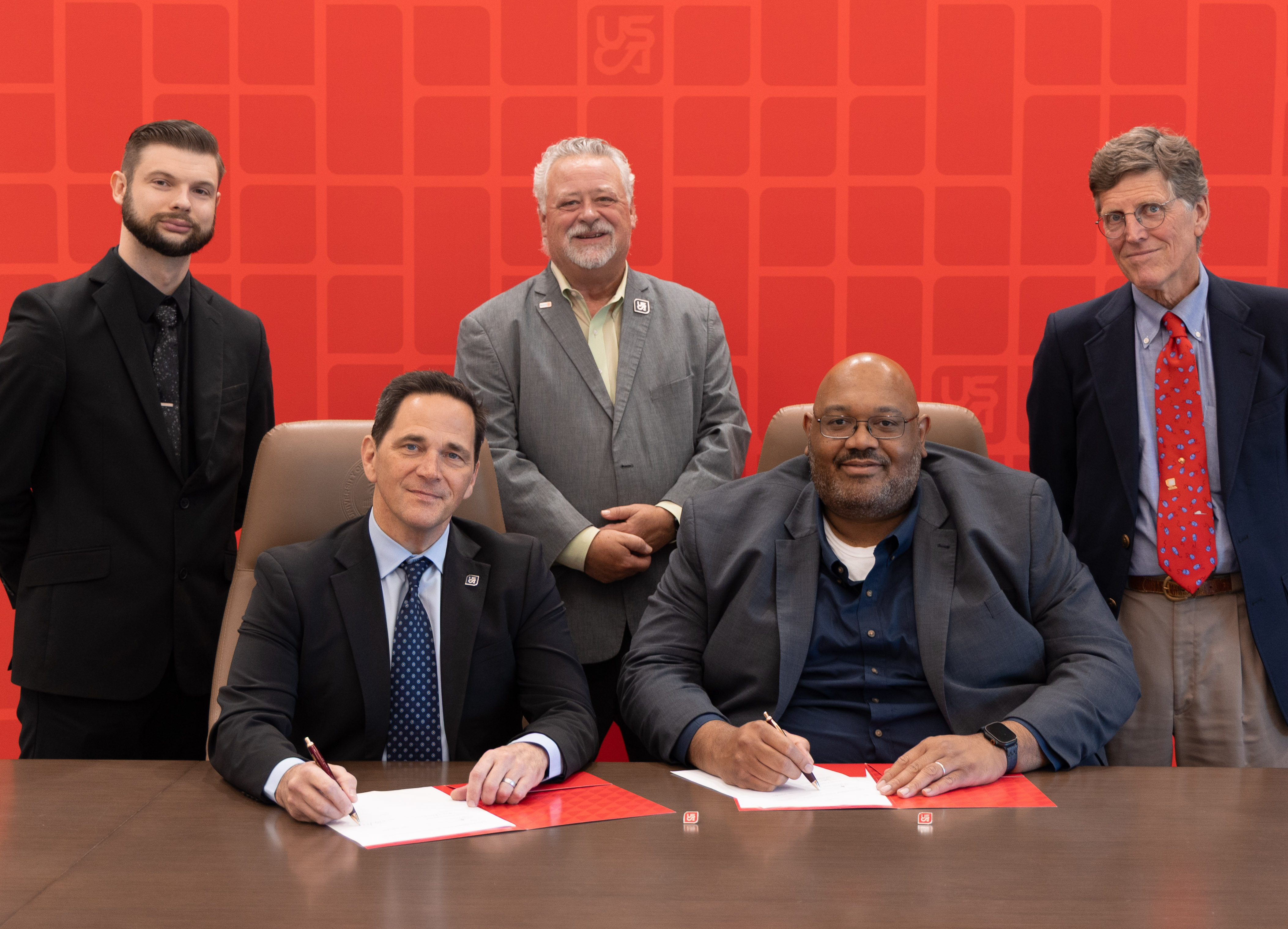 From left, Brent Hoover, Dr. Daniel J. Heimmermann, USCA chancellor, Tom Scott, South Carolina Small Business Development Centers State Director Marquise Jackson and Scott Bellows celebrate the signing of a memorandum of understanding Nov. 19, which will assist small businesses earn cyber certification needed to do business with the federal government.  [USCA photo by John Antaki]