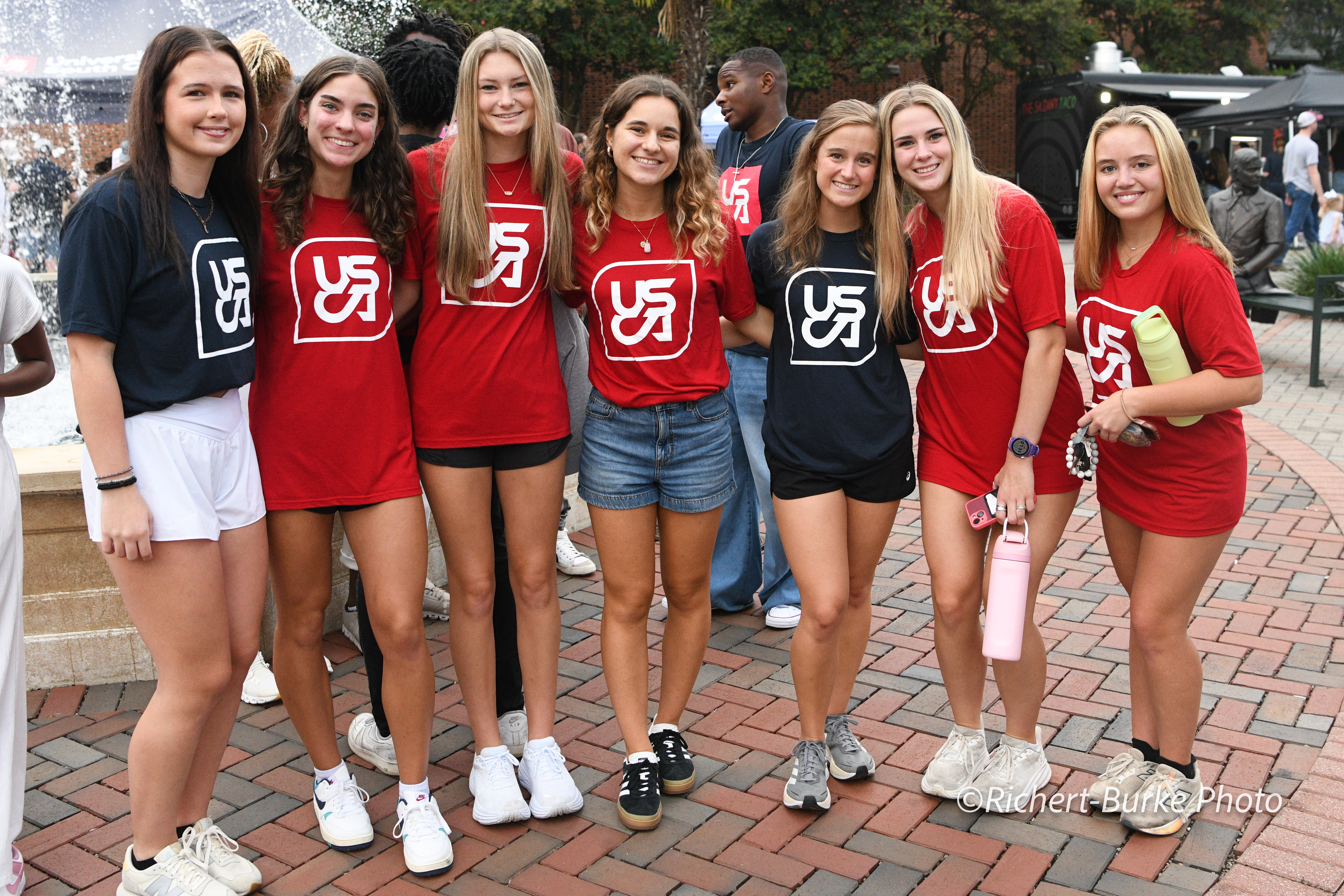 Students pose in T-shirts featuring the new icon.