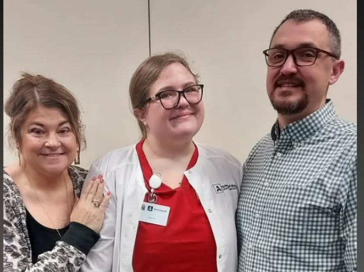 Alexa Carnahan (center) is pictured with her parents. Her passion for nursing was inspired by her late grandmother, a licensed practical nurse. (Courtesy photo)