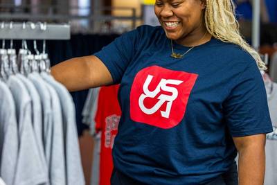 Photo of new student in the bookstore buying spirit gear