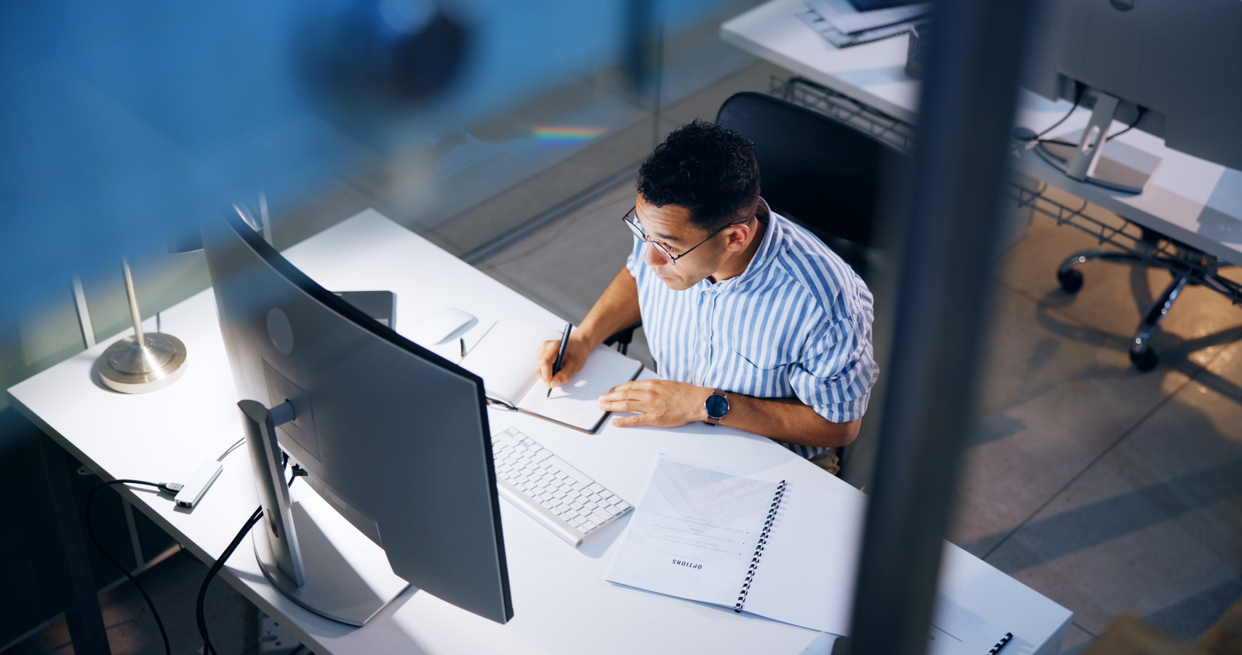 Photo of man at desk conducting research